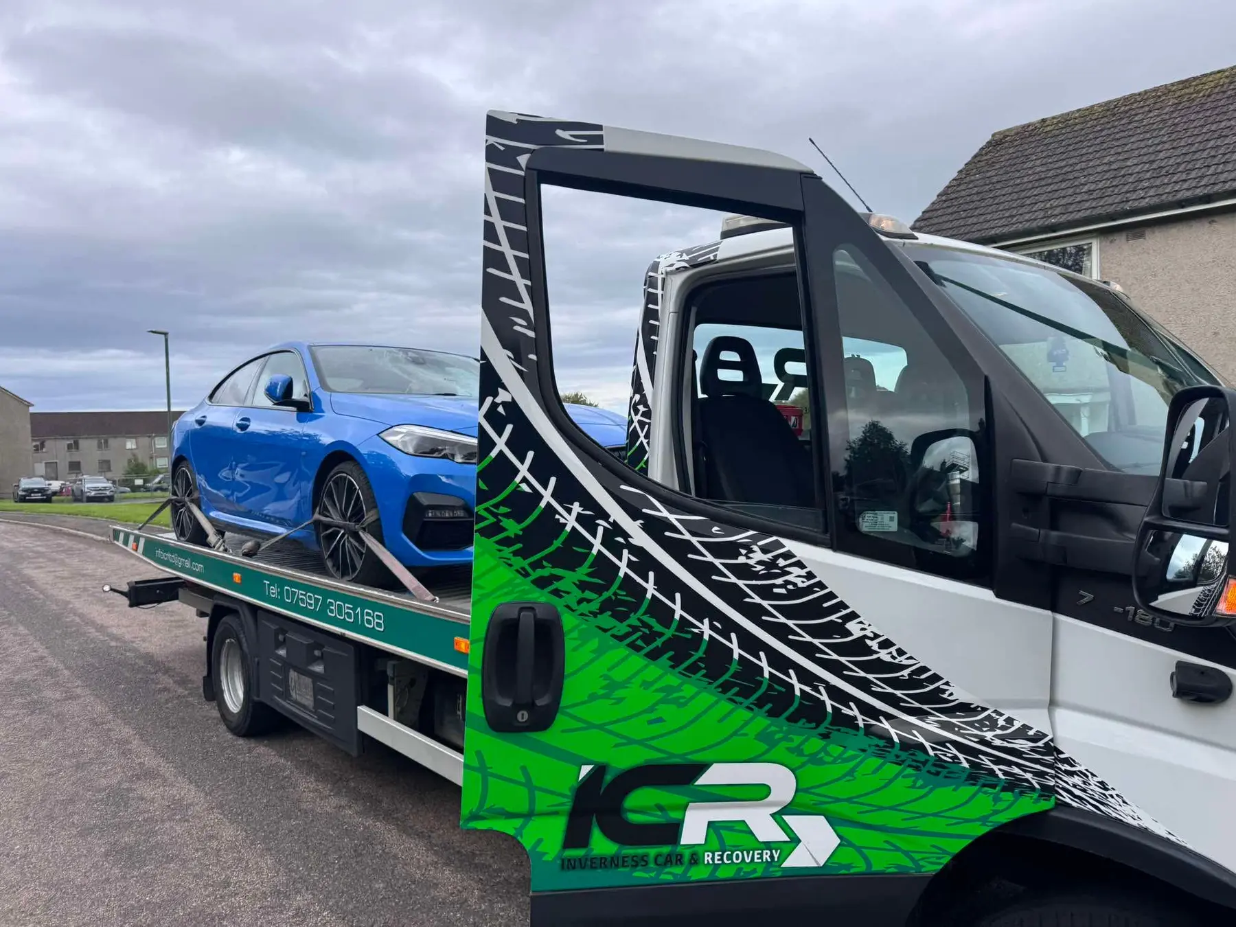 Blue car transported securely on the ICR recovery truck