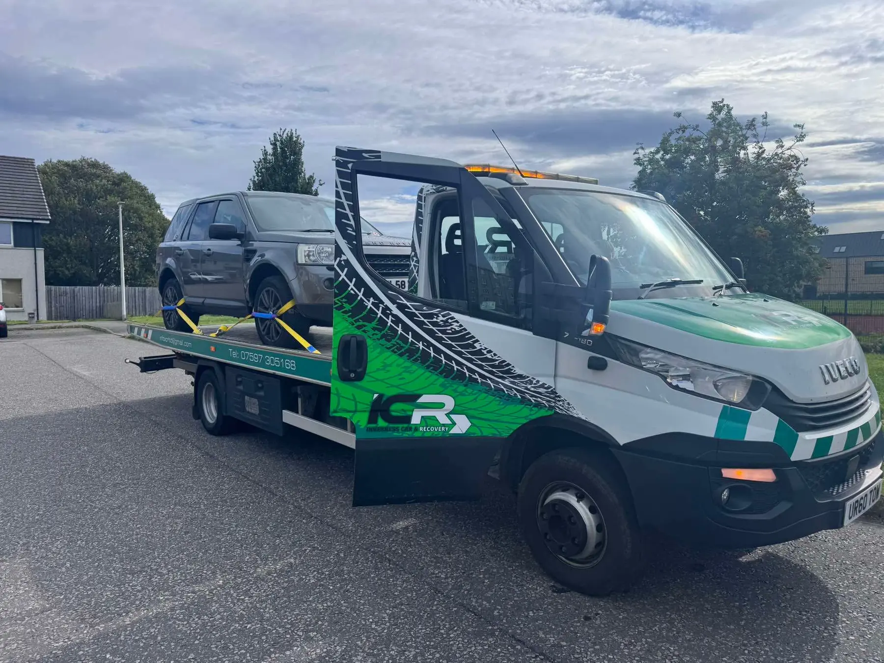 Black four-wheel-drive vehicle loaded onto the ICR truck