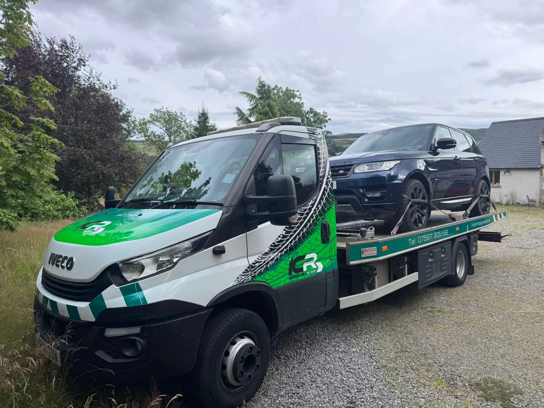Black SUV loaded on the branded ICR recovery truck