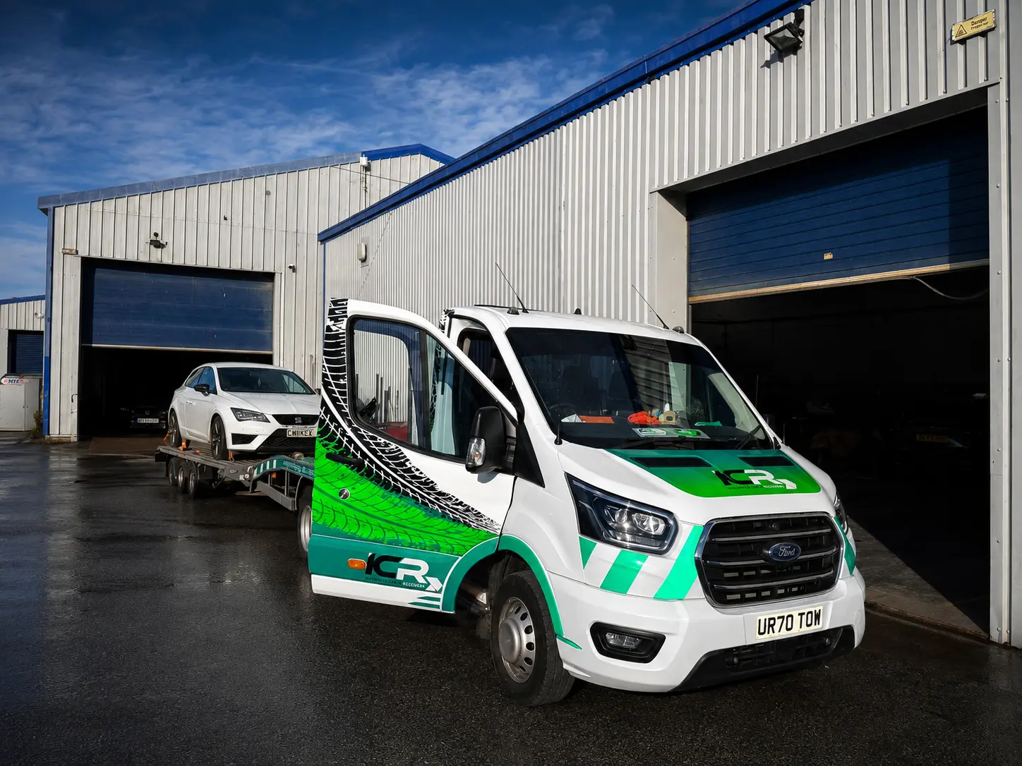 ICR recovery truck carrying a vehicle outside an Inverness workshop
